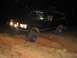 1988 Ford Bronco - This 1988 Ford Bronco is navigating a challenging dirt path after dark.