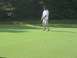 1988 Ford Bronco - A golfer lines up a putt on a sunny day on the green.