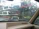1988 Ford Bronco - View from inside a 1988 Ford Bronco shows a rack filled with various truck caps on a rainy day.