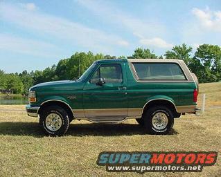 Green 1996 Ford Bronco side view with tan top