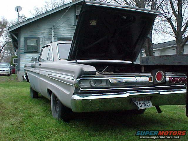 1964 Mercury Comet, light gray, rear view, hood open, grass and house in background