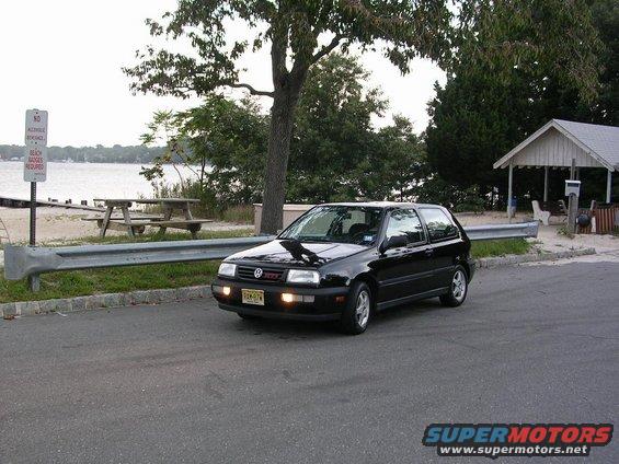 Black 1996 Volkswagen GTI parked by a beach with a red GTI badge