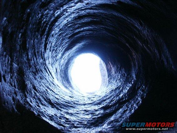 Dark tunnel with bright light at the end