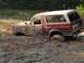 1989 Ford Bronco - This 1989 Ford Bronco is deeply embedded in thick mud, with only the top half visible.