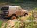 1989 Ford Bronco - This SUV is deeply stuck in the mud, with one wheel completely submerged in the muck.