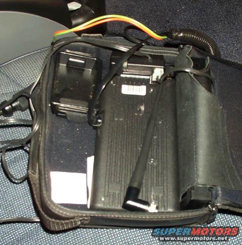 Bag with car electronics, wires, and a black antenna