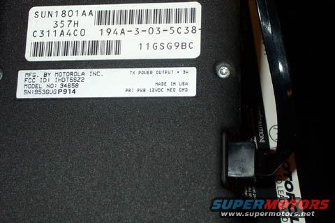 Close-up of a label on a black device, showing manufacturer and model info