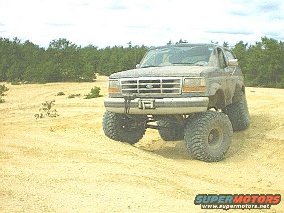 Ford Bronco with lifted suspension and large tires on a sandy terrain