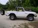 1967 Ford Bronco - A white first-generation Ford Bronco, possibly a 1967 model, is shown with a roll cage and an external spare tire mounted on the rear.
