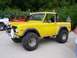 1967 Ford Bronco - Modified 1967 Ford Bronco and a red Jeep parked together outdoors.