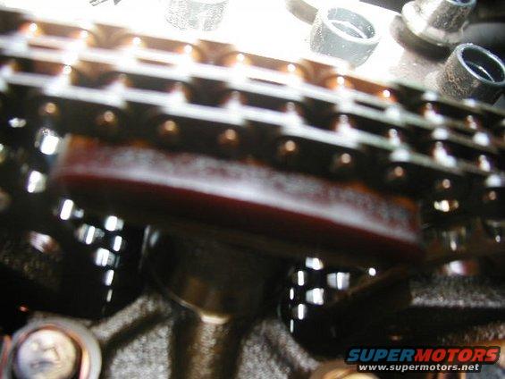 Close-up of a vehicle's timing chain and tensioner assembly