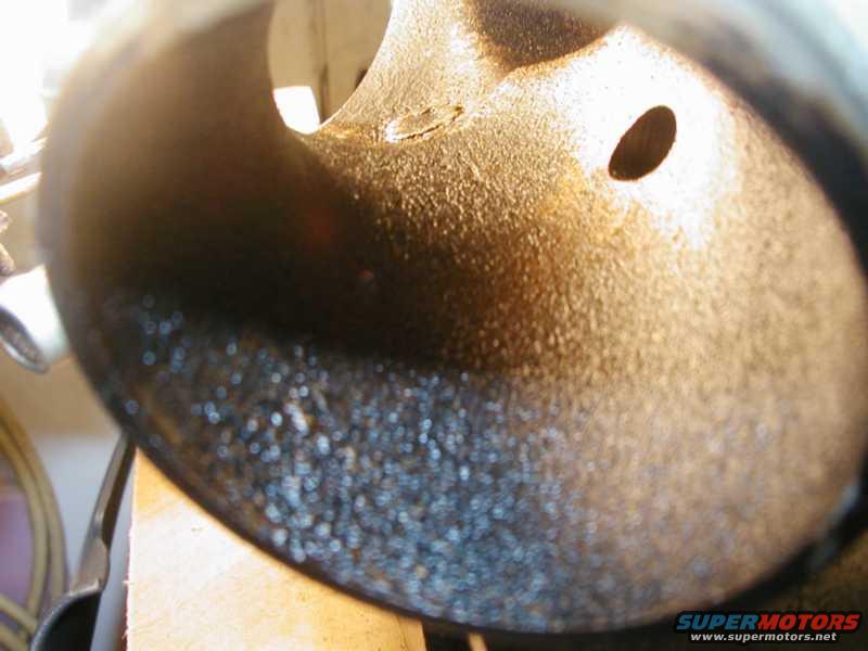 Interior of a dirty exhaust pipe with carbon buildup