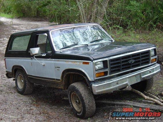 1980 Ford Bronco 3q-front view, black and silver two-tone paint, off-roading