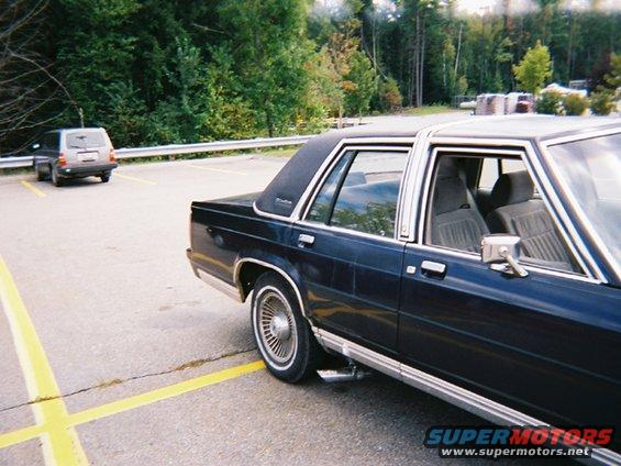 Dark blue 1990 Ford Crown Victoria LTD sedan, rear quarter view, parked in lot
