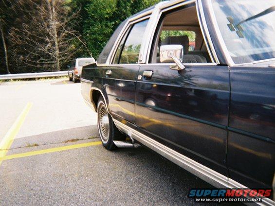 1990 Ford Crown Victoria LTD, side view, parked in a lot with another vehicle behind it