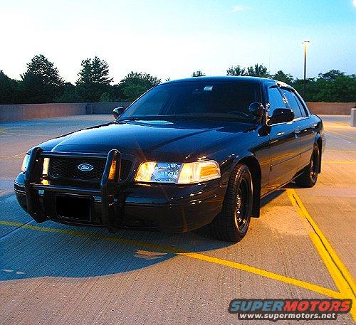 Black 2000 Ford Crown Victoria with push bar, 3/4 front view