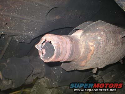 Damaged catalytic converter with a broken pipe end