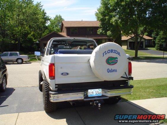 White Ford Bronco, rear view, with a spare tire cover the Florida Gators logo