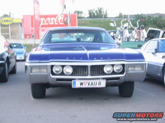 Blue sedan with quad headlights and a chrome grille. License plate reads W VAU 8