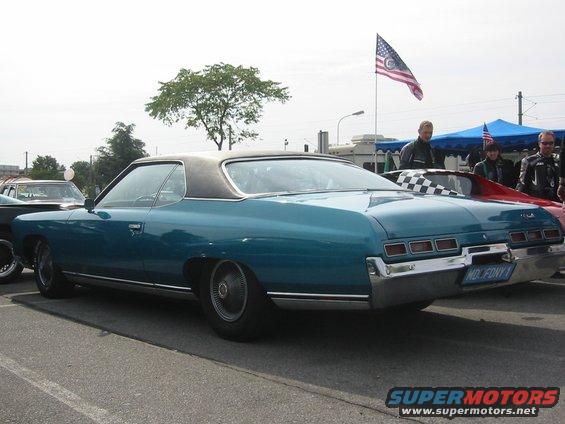 Teal 1971 Chevrolet Caprice coupe with black vinyl roof, parked outdoors. License plate reads 'MD. FONY 1'