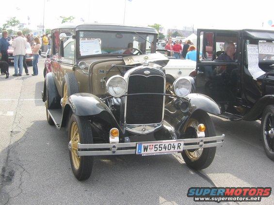 Brown and black 1930 Ford Model A with gold wheels and license plate W W55404 R