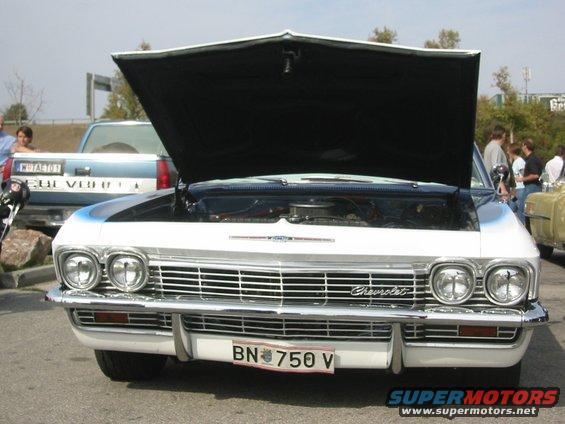 White 1965 Chevrolet Impala front view, hood open, showing engine