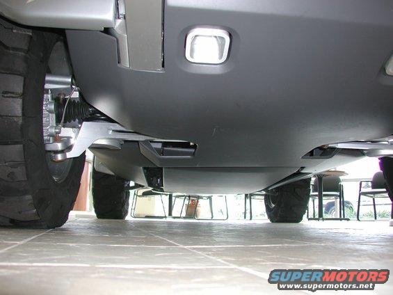 Underside view of a vehicle's suspension and large tires