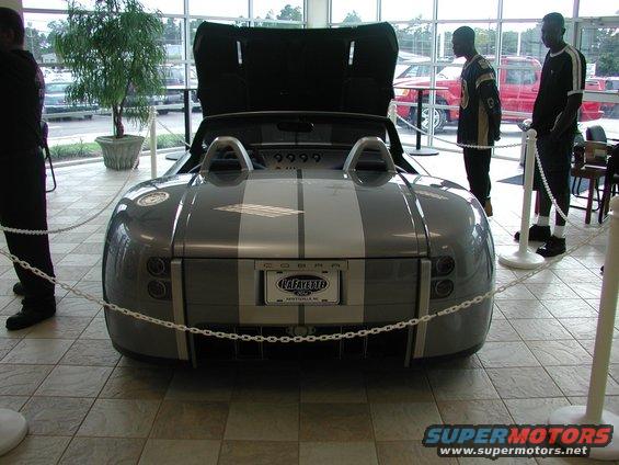 Gray Shelby Cobra concept car with silver stripes, hood open. License plate reads Lafayette Ford