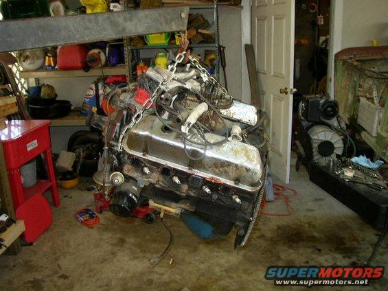 Engine suspended by chains in a garage