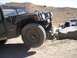 1988 Ford Bronco - Hummer H1 navigating rocky terrain with another SUV visible in the distance.