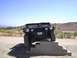 1988 Ford Bronco - A black Humvee is positioned on concrete steps in an outdoor, arid environment under a clear blue sky.