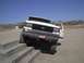 1988 Ford Bronco - White 1988 Ford Bronco with door open, climbing concrete steps in a dry, outdoor area.