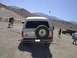 1988 Ford Bronco - A white 1988 Ford Bronco is parked outdoors with a spare tire mounted on the rear door. Another vehicle is visible in the background.
