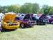 1978 Ford Mustang II - Several classic cars are displayed with their hoods up at an outdoor event.