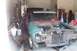 1966 Ford Fairlane - A partially disassembled 1966 Ford Fairlane sits in a garage with its hood open.