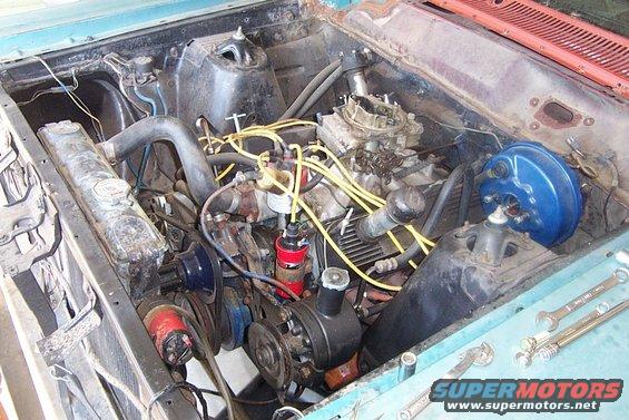 1966 Ford Fairlane engine bay with V8 engine, carburetor, and yellow spark plug wires