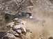 1989 Ford Bronco - This off-road vehicle navigates a challenging, dusty, and rocky path.