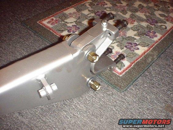 Silver suspension part with bolts and nuts