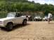 1967 Ford Bronco - A white 1966 Ford Bronco is parked by the water alongside other vehicles.