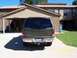 2000 Ford Excursion - Rear view of a 2000 Ford Excursion parked outside a residential building.