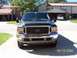 2000 Ford Excursion - A black Ford Excursion is shown from the front, parked outside a residential building.