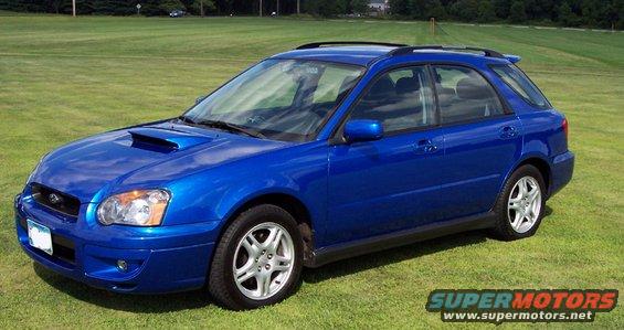 Blue 2004 Subaru Impreza wagon parked on grass with a hood scoop