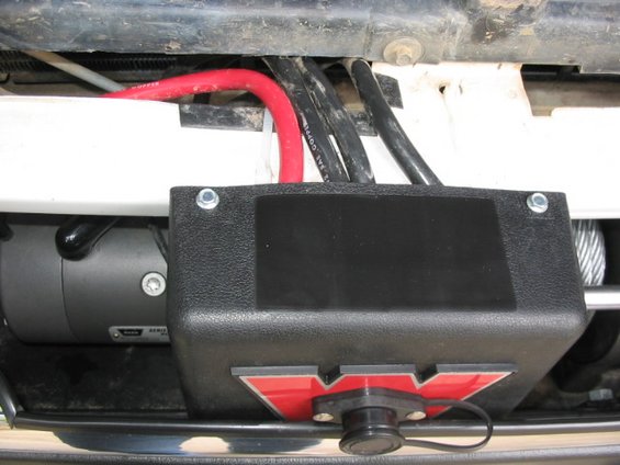 105_0518.jpg solenoid mount again, this time with Grille removed.  Note black plastic edging to protect cables.  Solenoid ziptied to the white metal body piece.