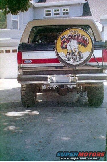 1991 Ford Bronco rear view showing spare tire cover with cartoon