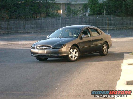 Gray 2002 Ford Taurus sedan parked on asphalt
