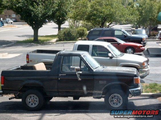 Black 1987 Ford Bronco parked next to other vehicles