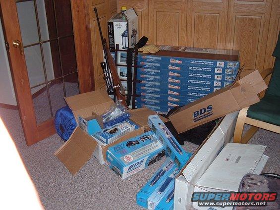 Boxes of BDS suspension parts and a rifle