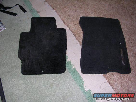 Two black carpeted car floor mats, one with 'PROBE' text