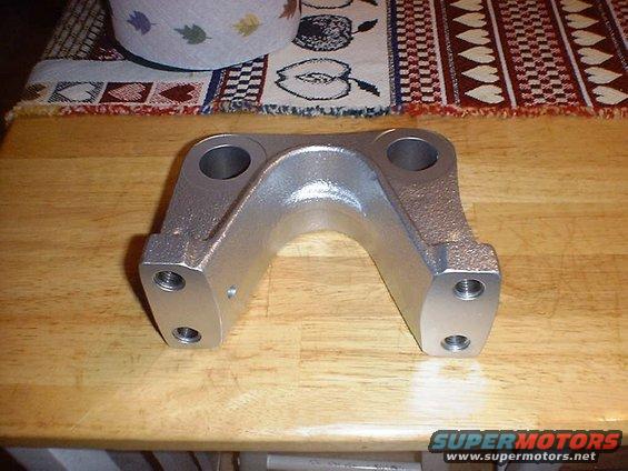 metal suspension part with two large holes and four smaller threaded holes