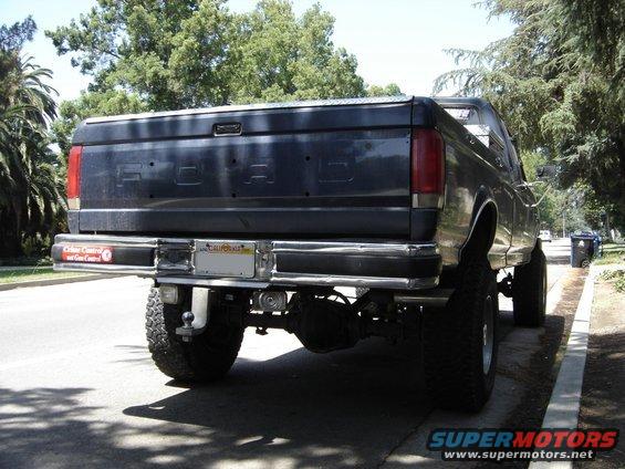 Dark blue 1987 Ford F-250 pickup truck rear view with lifted suspension